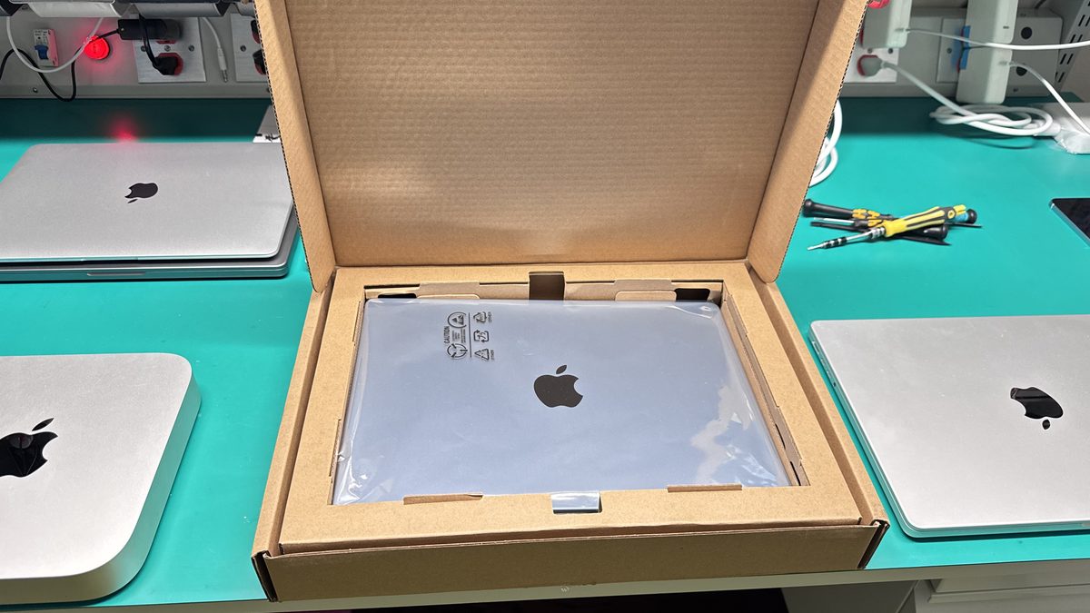 A full MacBook display replacement module showing the hinges and assembly ready for installation