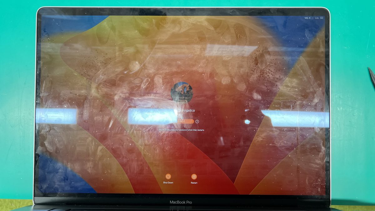 Affected MacBook Pro showing screen coating damage alongside backlight issues from Flexgate