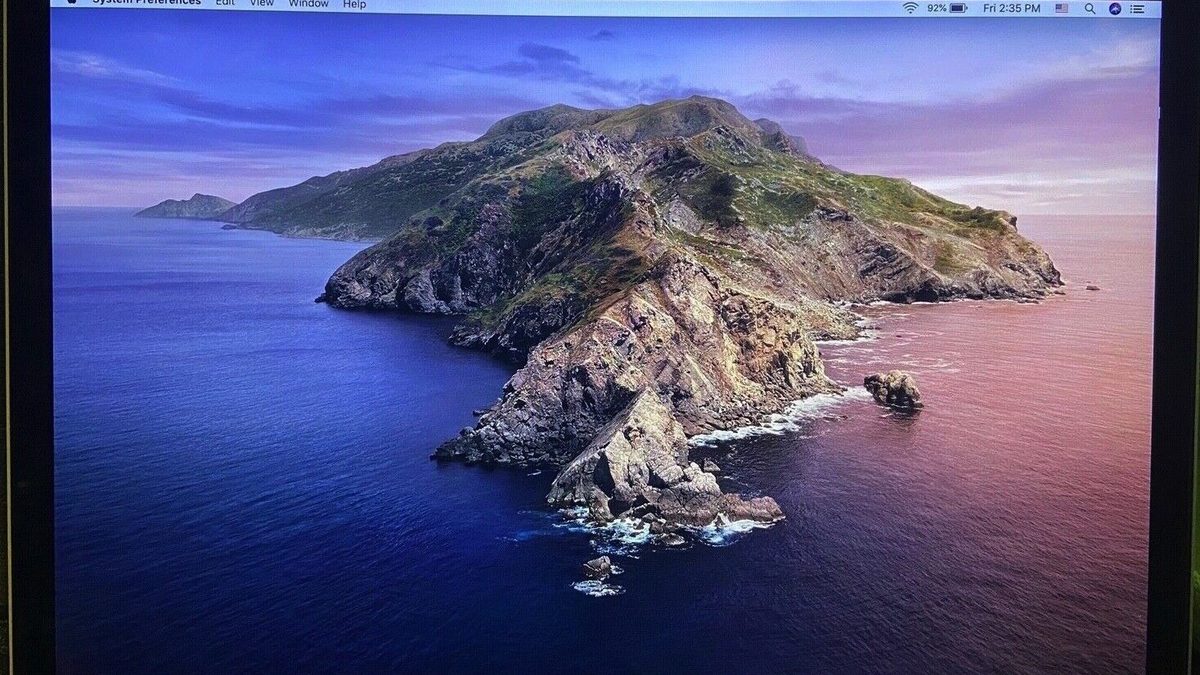 A Retina MacBook Pro with the lid open showing the macOS Catalina desktop on its high-resolution display