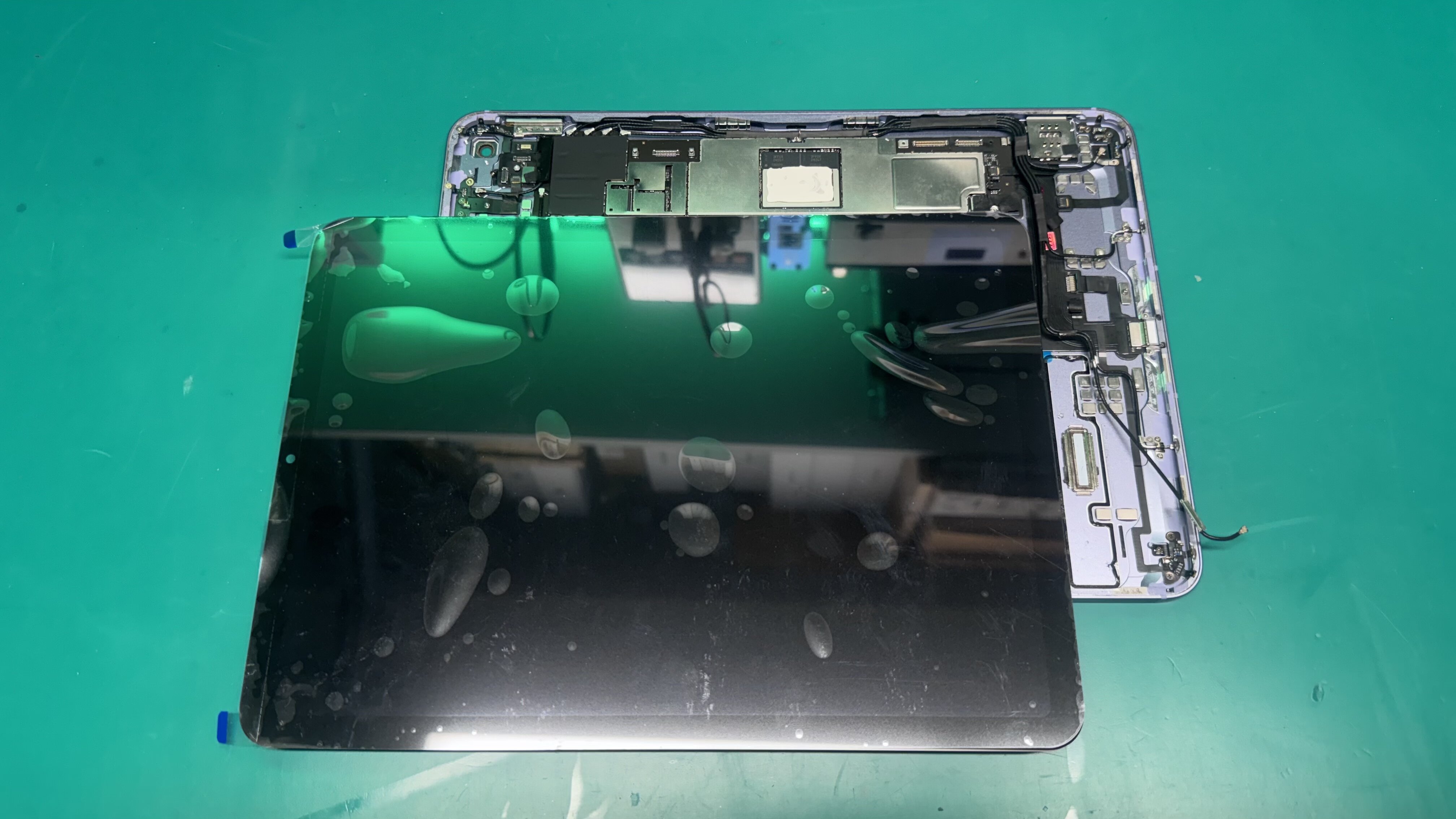 iPad with screen separated showing internal components at WarriorMac