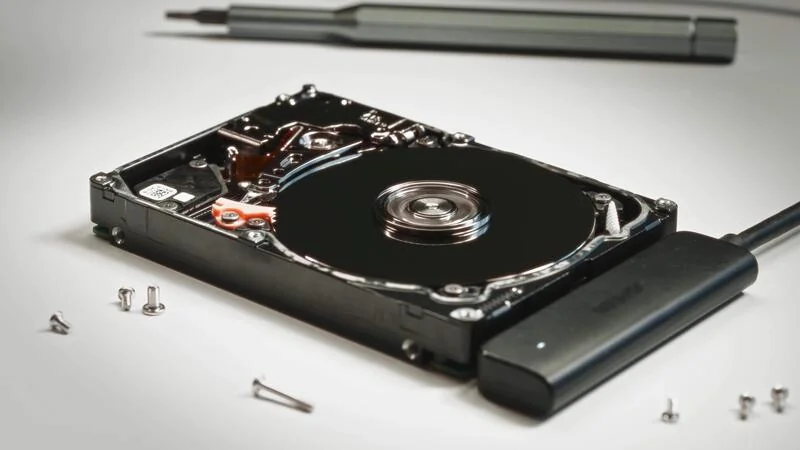 Opened hard drive showing platters and read-write heads during professional data recovery at WarriorMac Tampa