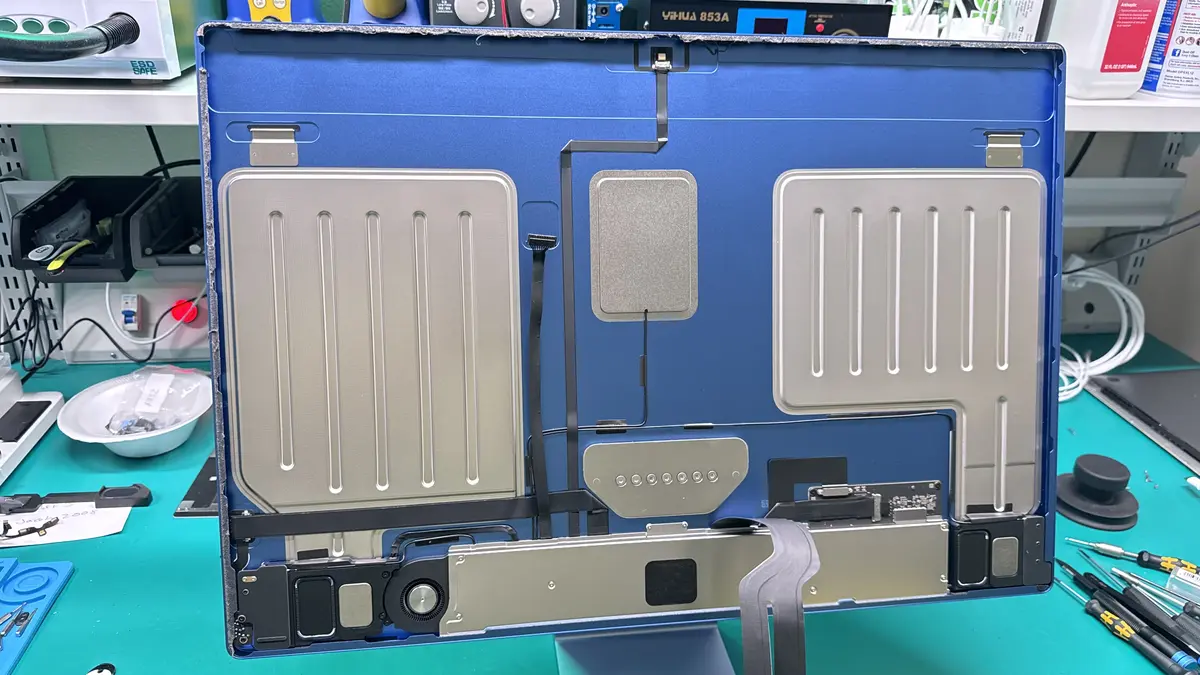 iMac back panel removed showing speakers, display cable, and internal components during SSD upgrade at WarriorMac