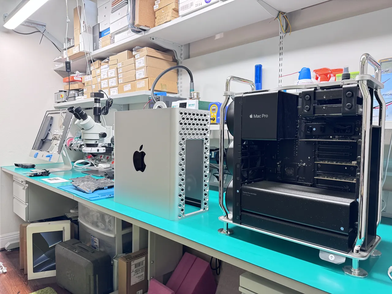 Mac Pro 2019 tower with side panel open showing Radeon Pro GPU module and internal components at WarriorMac repair bench
