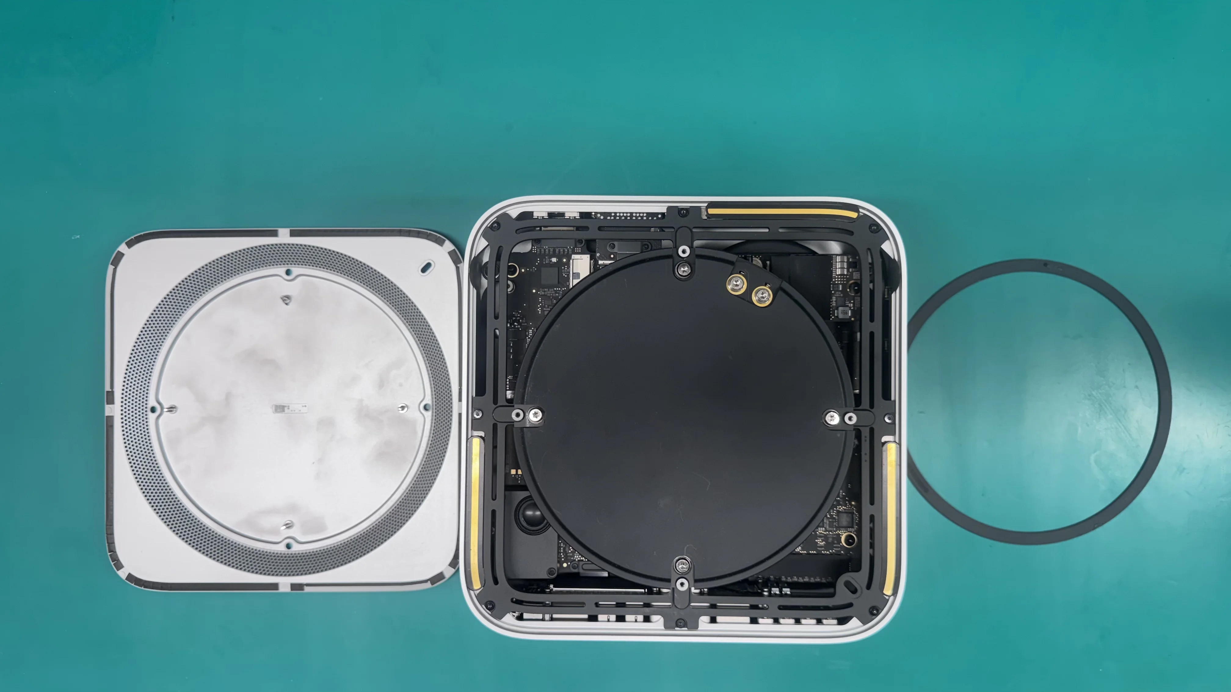 Mac Studio opened showing internal components and logic board on WarriorMac repair workbench