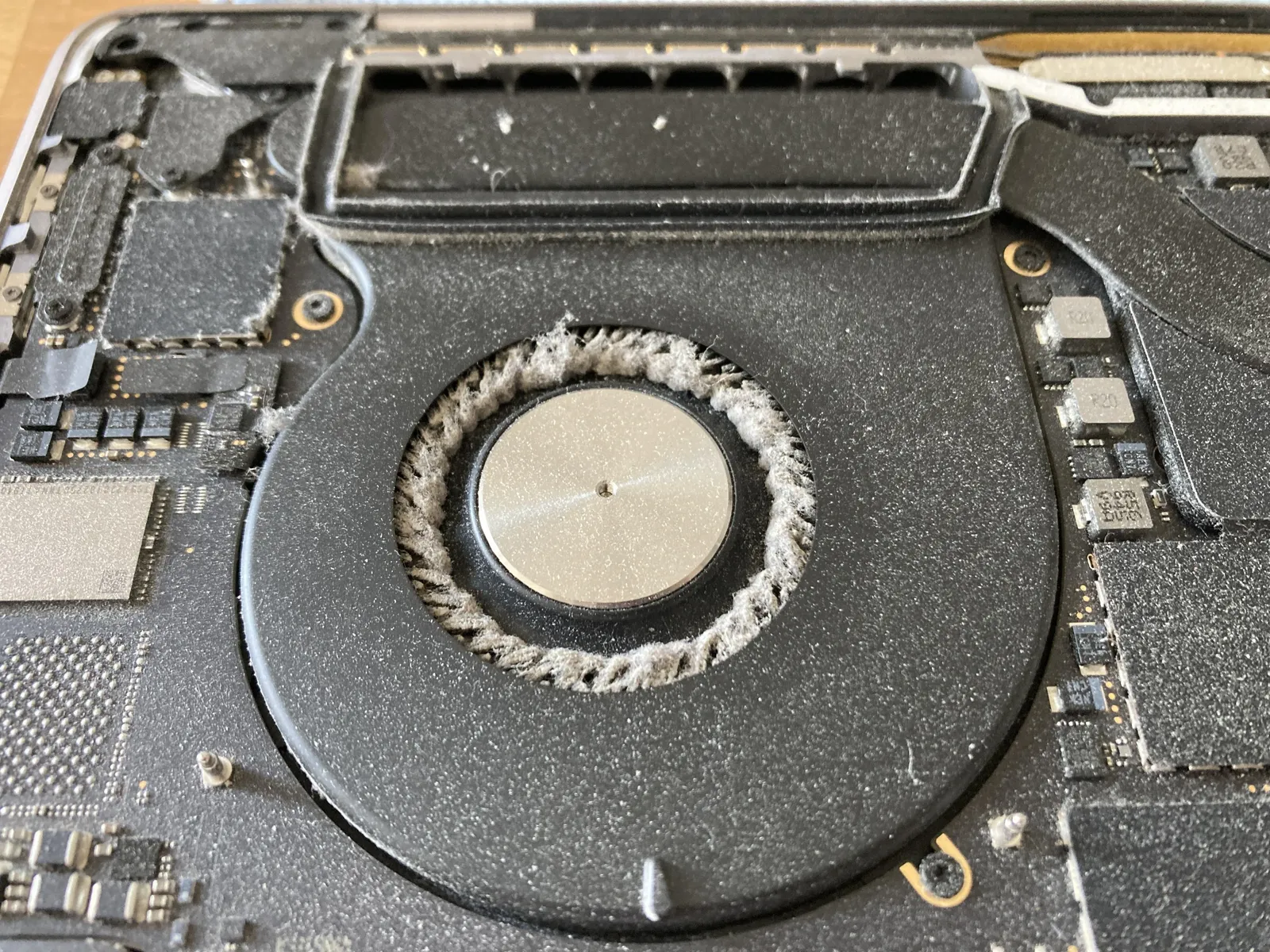 MacBook fan and cooling system cleaning to remove dust buildup