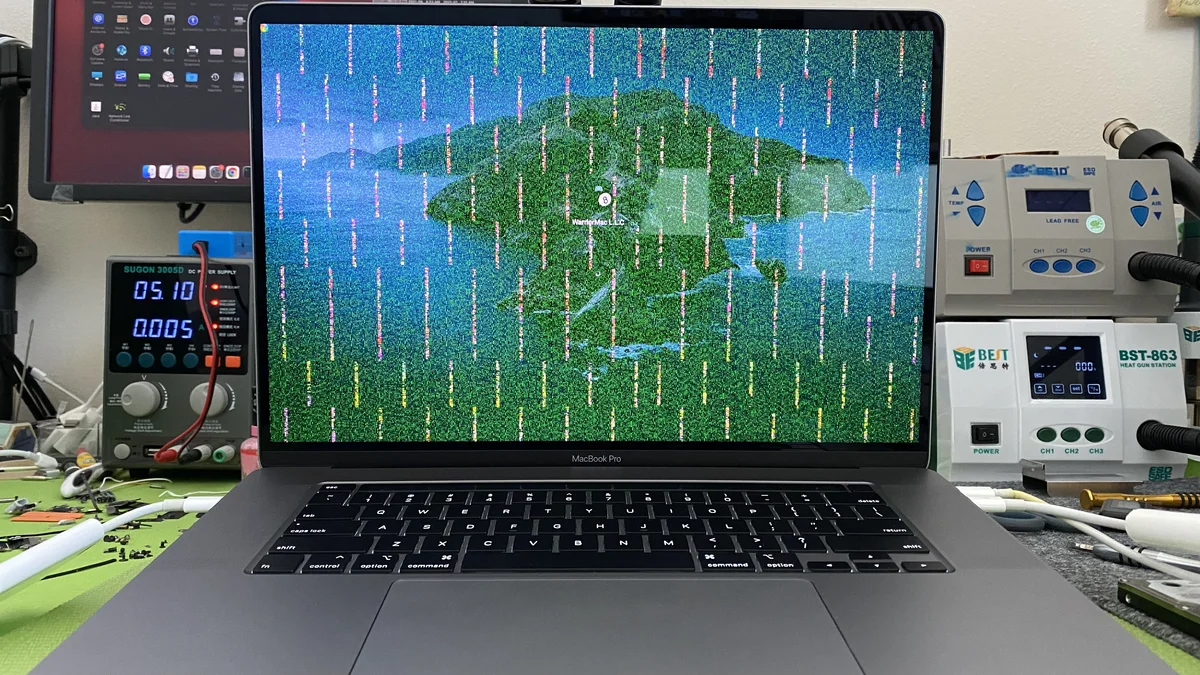MacBook Pro 15-inch with GPU artifacts on screen at WarriorMac repair bench
