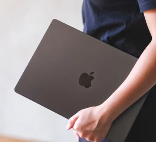 MacBook specialized repair services at WarriorMac Tampa — person holding MacBook